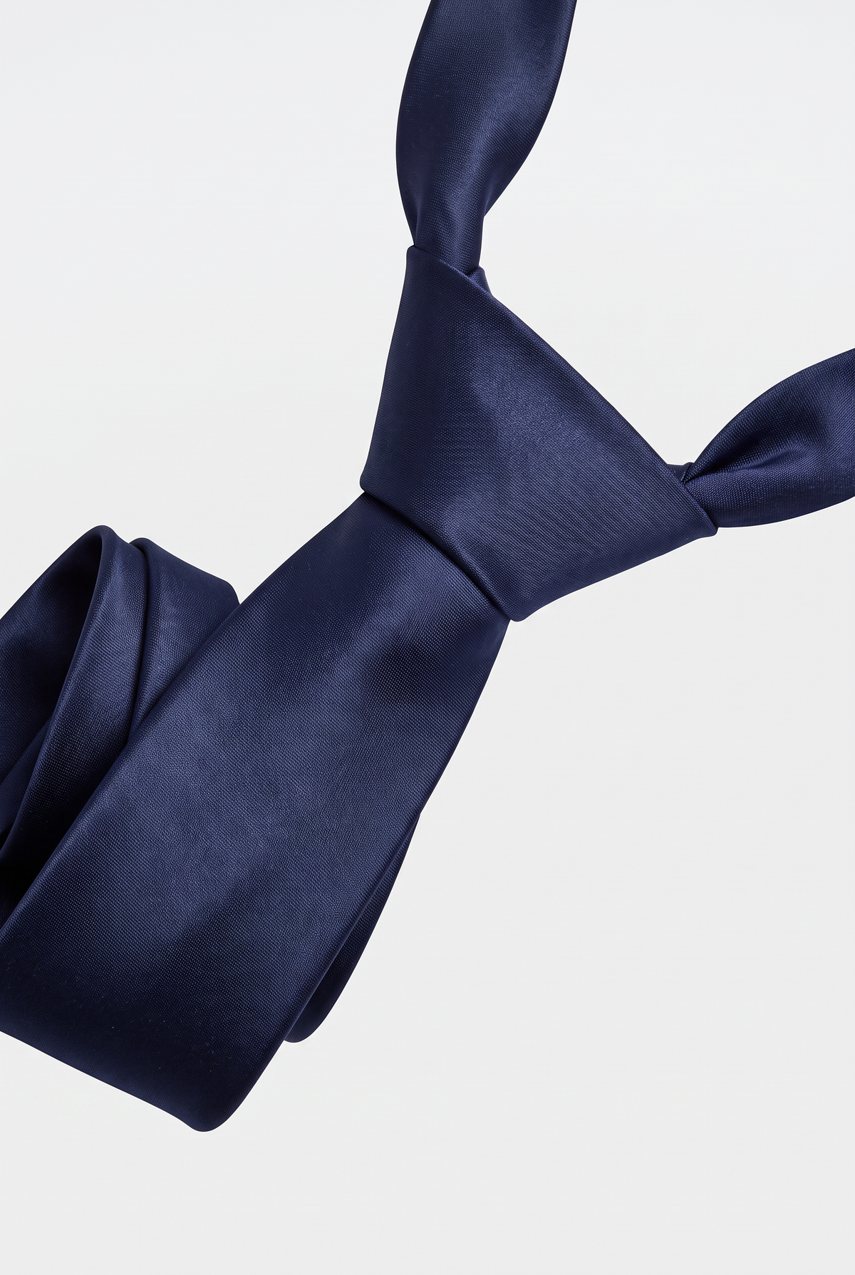 Navy satin necktie showing knot and fabric texture close-up