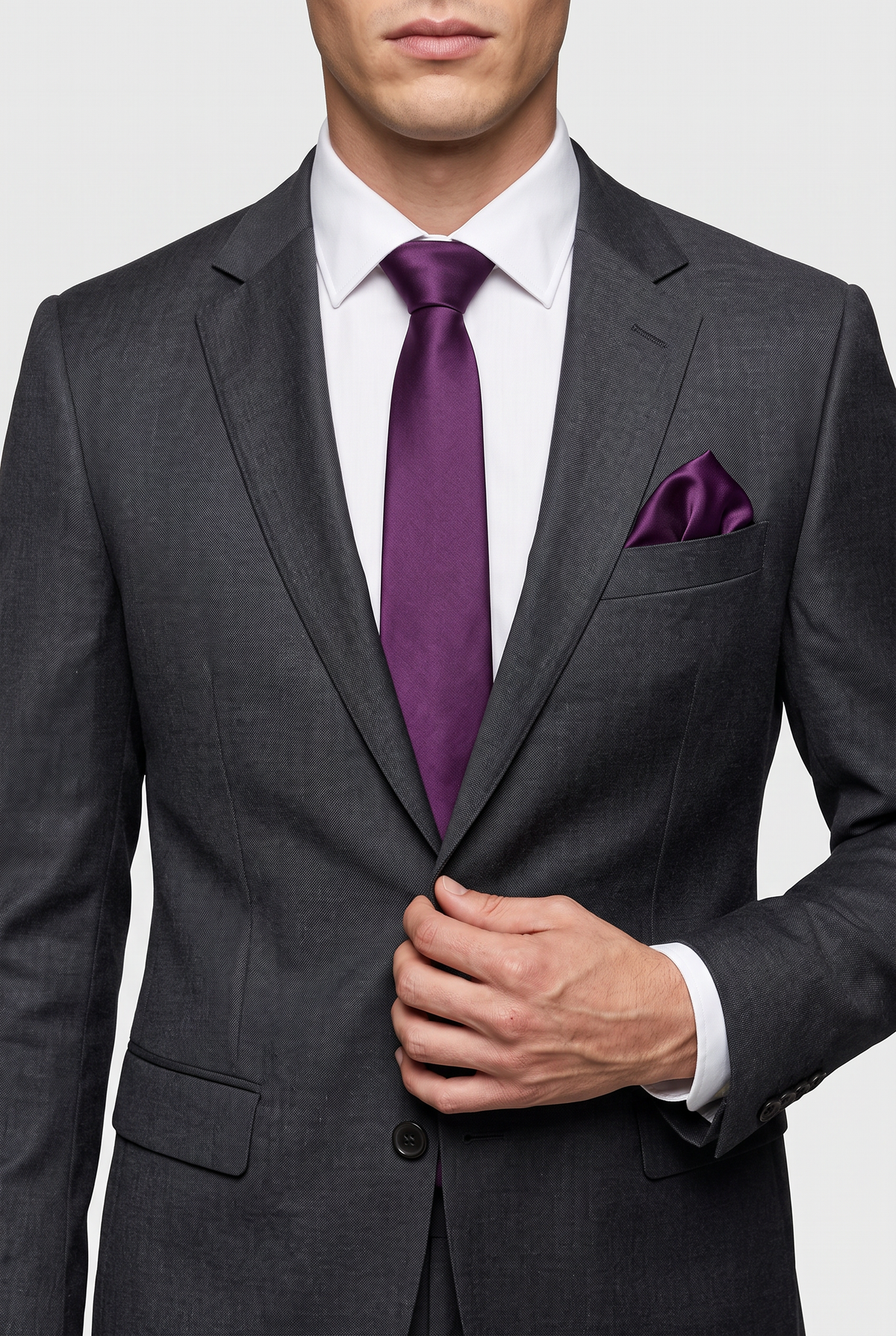 Purple satin tie and pocket square styled with a black suit