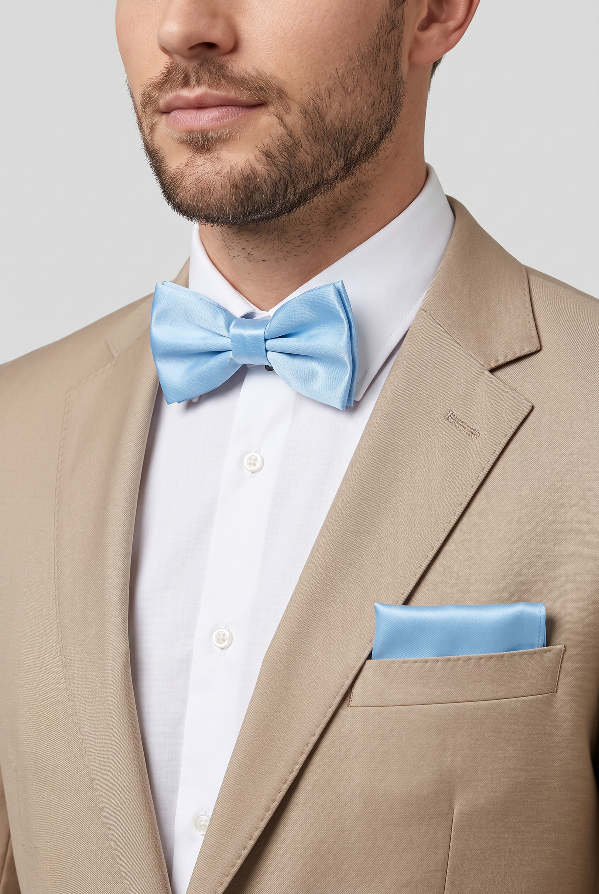 Men wearing a sky blue satin bow tie and matching pocket square with a suit