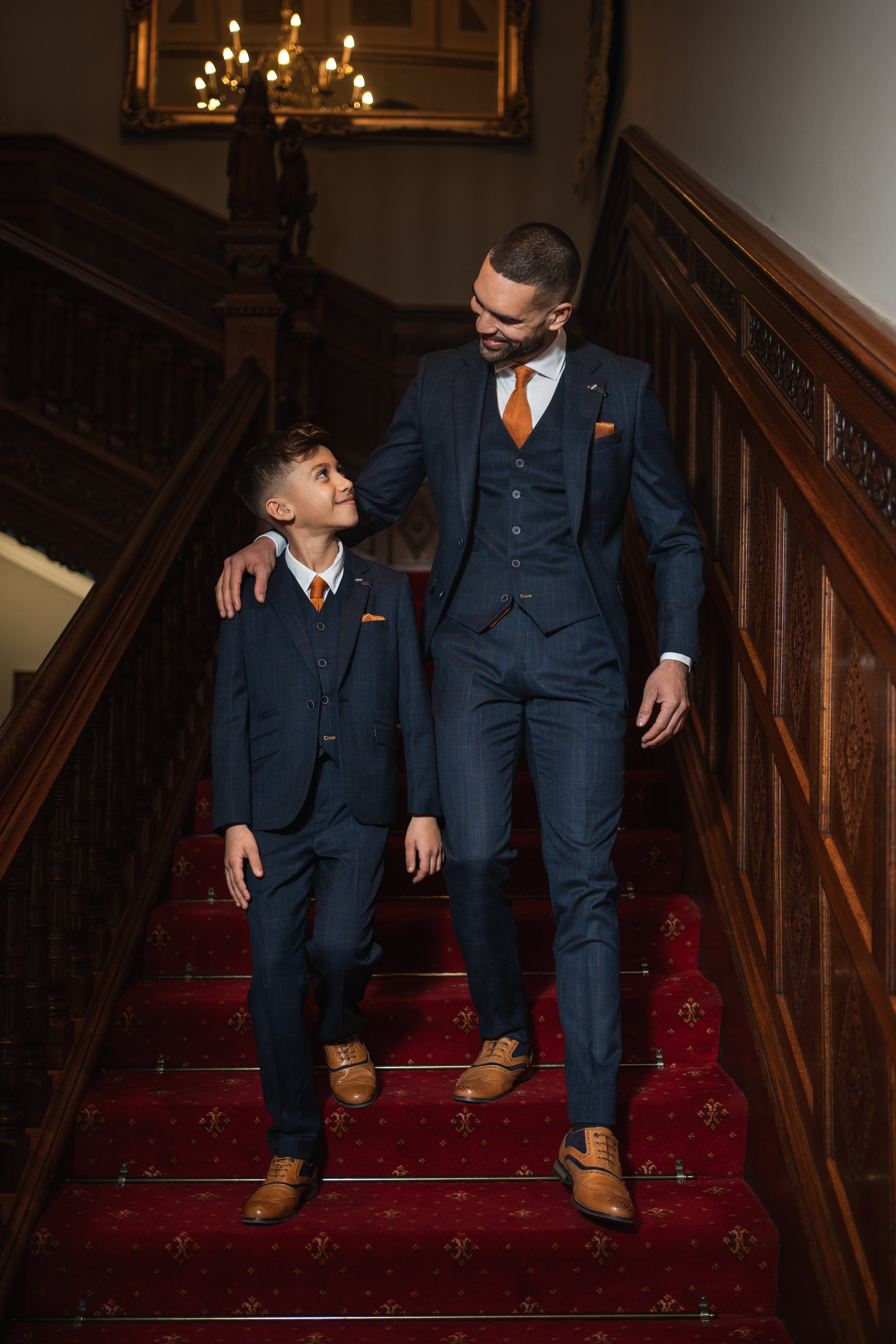 Father and son wearing a matching suit to a wedding