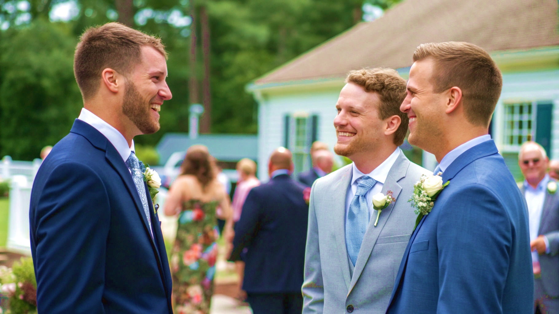 3 Men in Suits Standing and Talking at a Summer Wedding