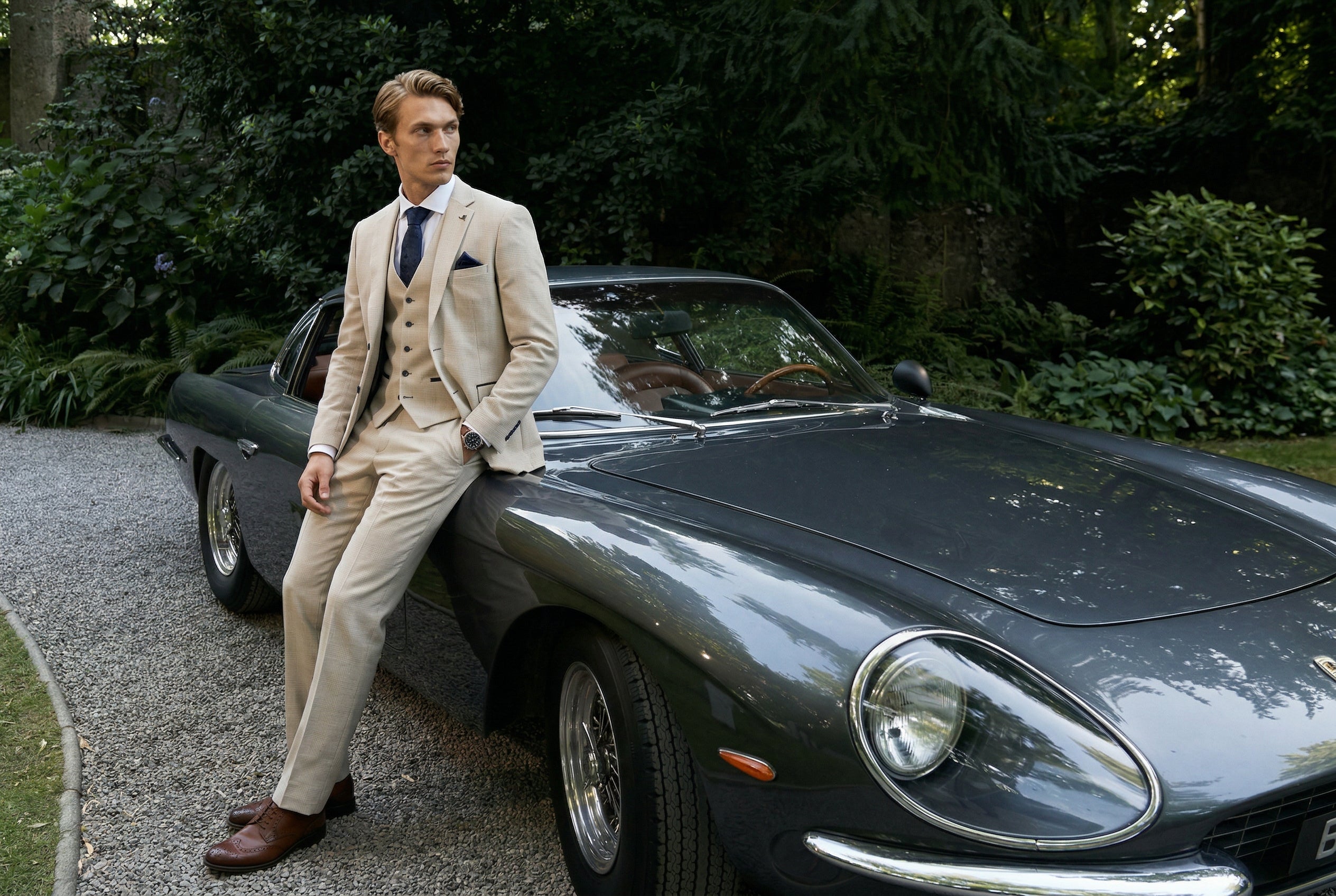 A man wearing a cream check suit for a summer cocktail event.