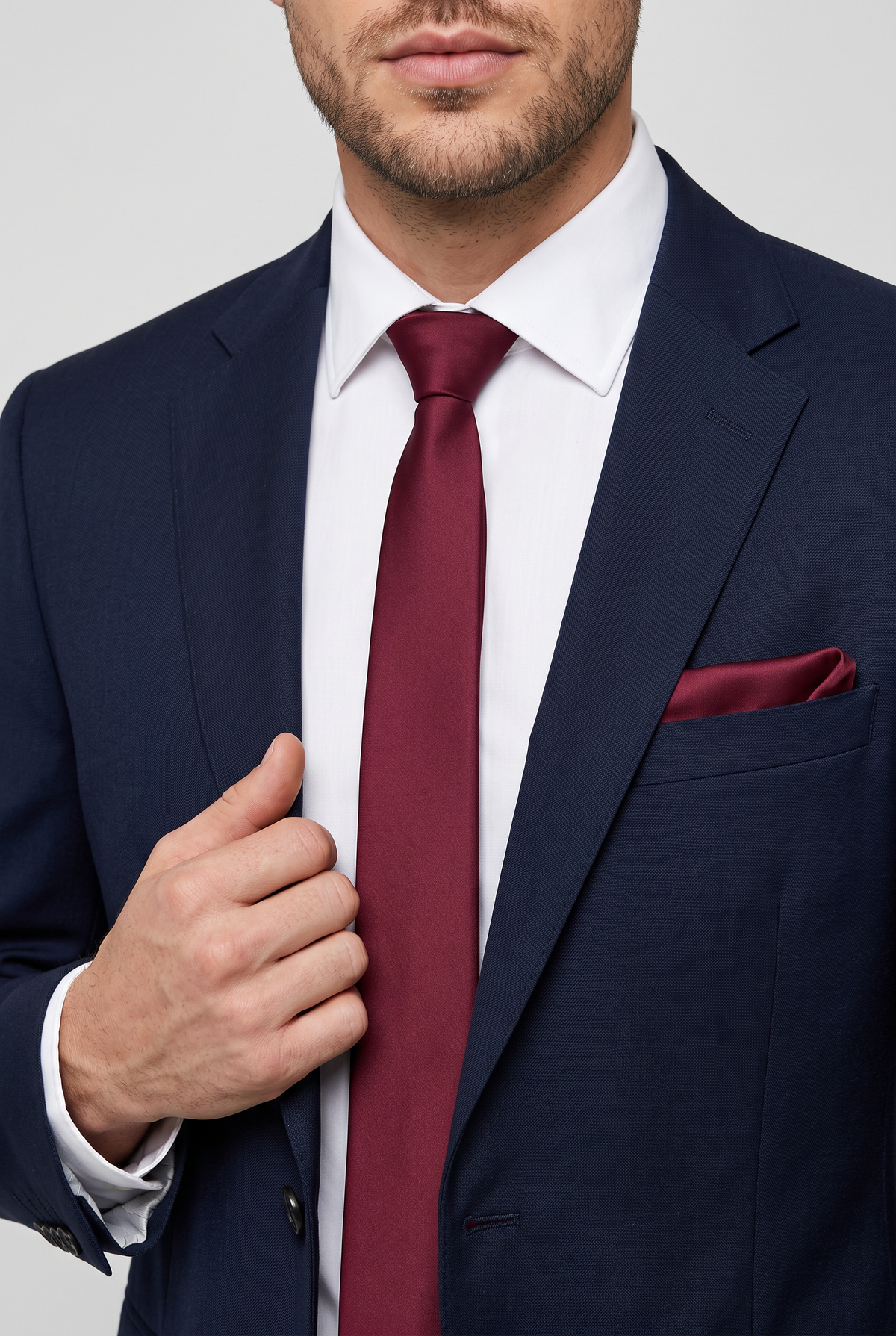 Burgundy satin tie and pocket square styled with a navy  suit