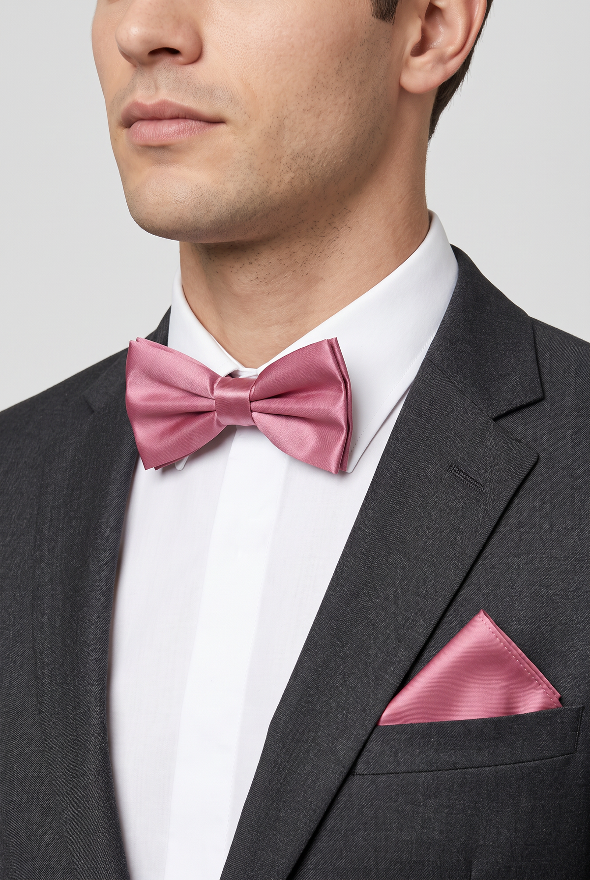 Men wearing a violet satin bow tie and matching pocket square with a suit