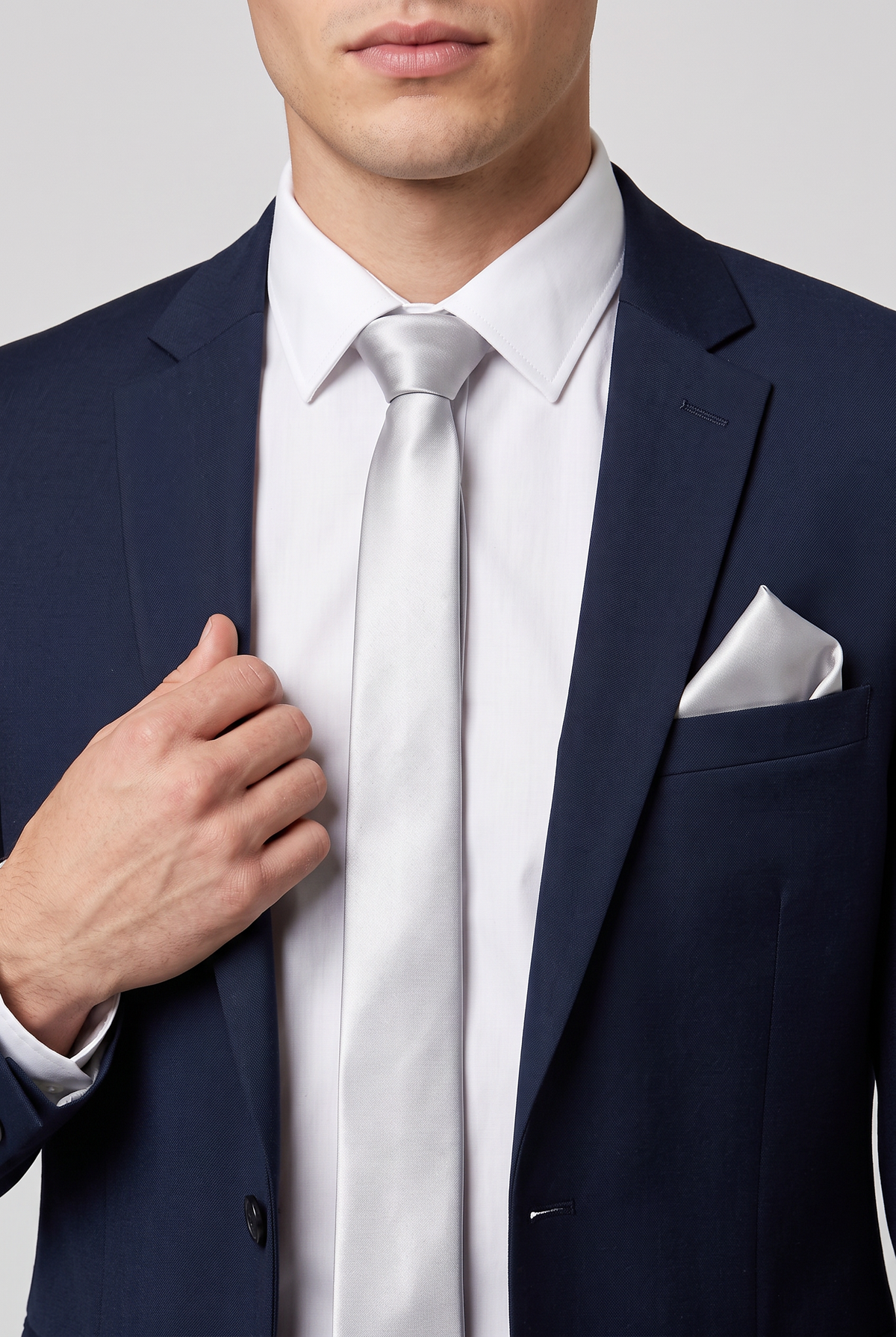 Silver satin tie and pocket square styled with a black suit